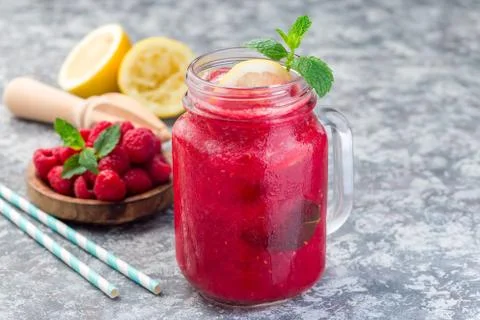 Refreshing raspberry, lemon and mint lemonade with sparkling water in  jar Фото