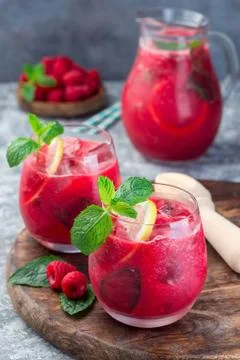Refreshing raspberry, lemon and mint lemonade with sparkling water in a glass Stock Photos