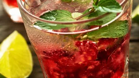 Refreshing raspberry mint cocktail with lime garnish Stock Photos