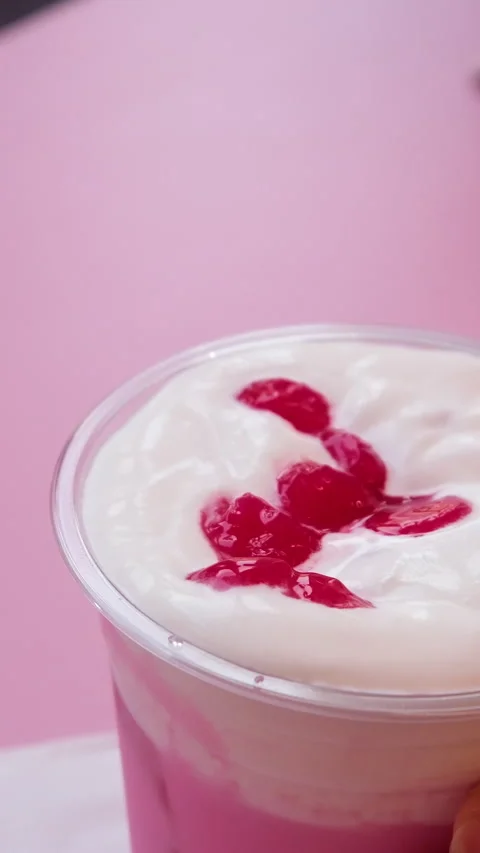 Refreshing raspberry smoothie beverage filmed from above on table.Delicious Stock Footage 313127108