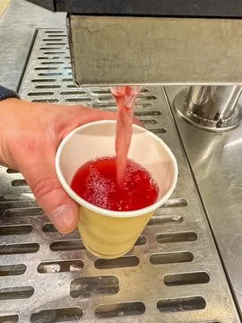 Refreshing Red Beverage Dispensing into Paper Cup at Drink Station Stock Photos