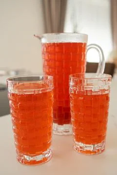 Refreshing Red Drink in Elegant Crystal Glassware Foto stock