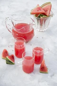 Refreshing red watermelon drink on hot summer day on light gray cement Stock Photos