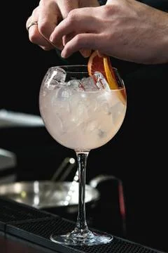 Refreshing ruby red coctail with grape fruit isolated on a bar background Stock Photos