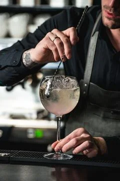 Refreshing ruby red coctail with grape fruit isolated on a bar background Stock Photos