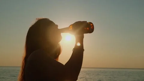 A refreshing sip of beer on a hot summer evening on vacation. Stock Footage 311528452