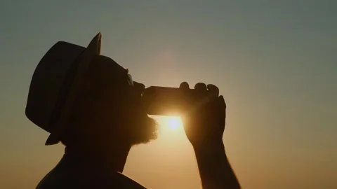 A refreshing sip of cold drink on a hot summer evening on vacation. Stock Footage 306030514