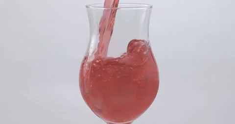 Refreshing Slow Motion Pour: Liquid Filling a Glass with Fruit and Ice - Vibrant Stock Footage 273531891