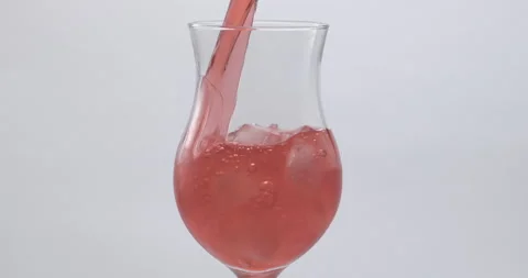 Refreshing Slow Motion Pour: Liquid Filling a Glass with Fruit and Ice - Vibrant Stock-Footage 273531943