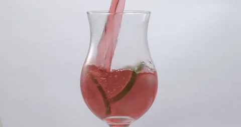 Refreshing Slow Motion Pour: Liquid Filling a Glass with Fruit and Ice - Vibrant Stock Footage 273531951