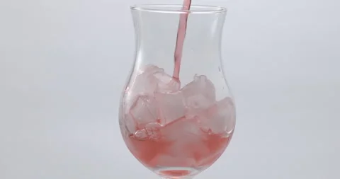 Refreshing Slow Motion Pour: Liquid Filling a Glass with Fruit and Ice - Vibrant Stock Footage 273531995