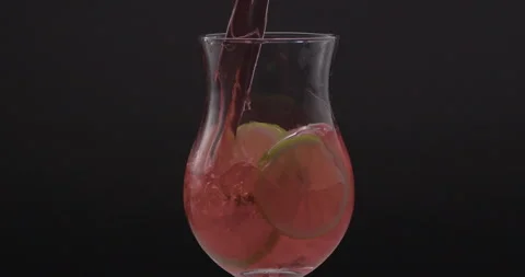 Refreshing Slow Motion Pour: Liquid Filling a Glass with Fruit and Ice - Vibrant Stock Footage 273532020