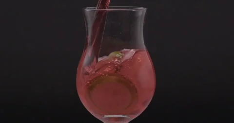 Refreshing Slow Motion Pour: Liquid Filling a Glass with Fruit and Ice - Vibrant Stock Footage 273532242