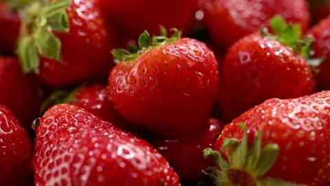 Refreshing slow-motion water splash on ripe strawberries. 스톡 동영상 314332853
