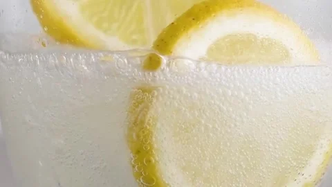 Refreshing Soda Pour with Ice and Lemon Stock Footage 334105964