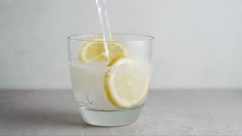 Refreshing Soda Pour with Ice and Lemon Stock Footage 334106028