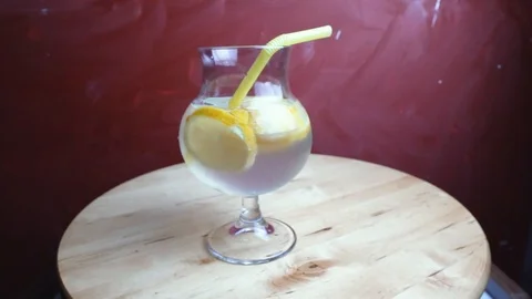 Refreshing soda tonic with lemon and ice in a glass. Cold lemonade mojito drink. Stock-Footage 107739060