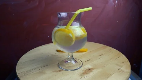 Refreshing soda tonic with lemon and ice in a glass. Cold lemonade mojito drink. Stock-Footage 107739209