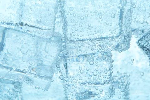 Refreshing soda water with ice cubes as background, closeup 写真素材