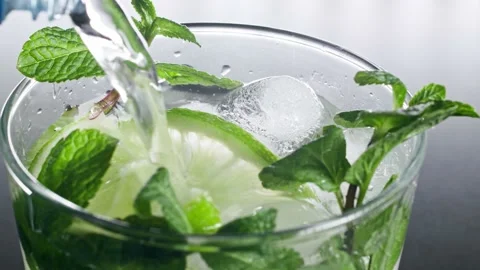A refreshing soft drink. Mojito is poured into a glass close-up. Lemon mint Stock-Footage 148161846