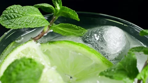 A refreshing soft drink. Mojito is poured into a glass close-up. Lemon mint Stock-Footage 148161951