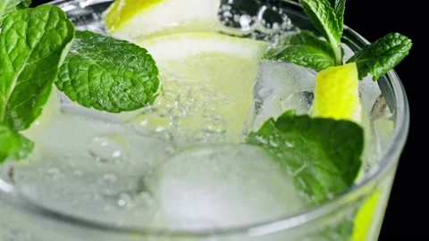 A refreshing soft drink. Mojito is poured into a glass close-up. Lemon mint Stock-Footage 148162064