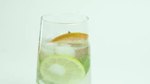 A refreshing soft drink. Mojito is poured into a glass close-up. Lemon mint and Stock Footage 265492226