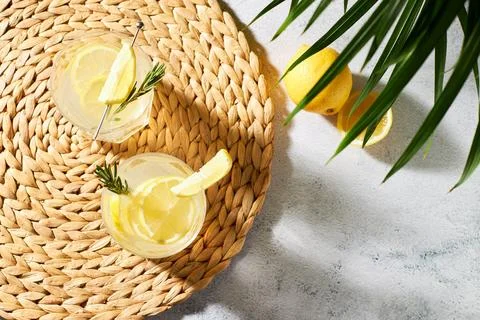 Refreshing soft drinks with fresh lemon and lime slices, garnished with a sprig Stock Photos