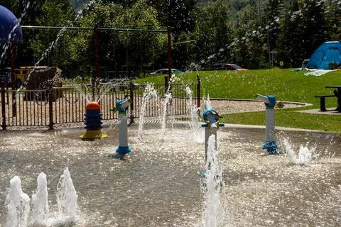 A refreshing splash pad with various spraying features for summertime fun. Stock Photos