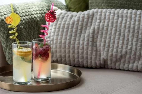 Refreshing strawberry and lemon drinks on a sofa tray Stock Photos