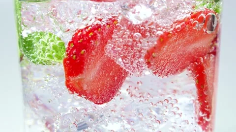 Refreshing strawberry lemonade or mojito cocktail with ice cubes and mint leaves Stock Footage 244313083