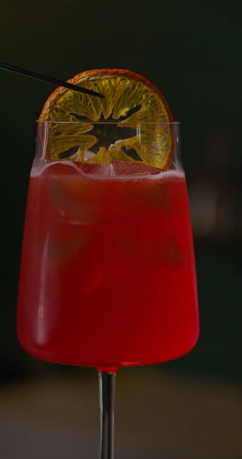 Refreshing summer cocktail at the bar, bartender garnishing red cocktail with Stock Footage 312356200