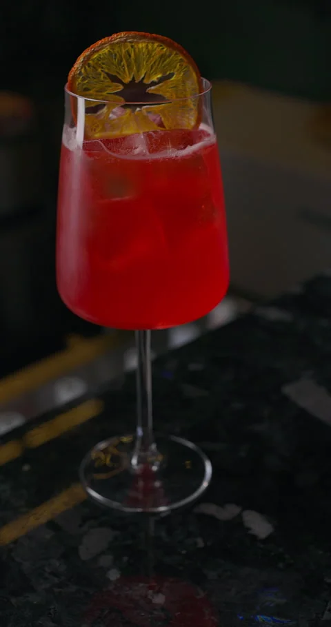 Refreshing summer cocktail at the bar, bartender preparing red alcohol drink Stock Footage 312643231