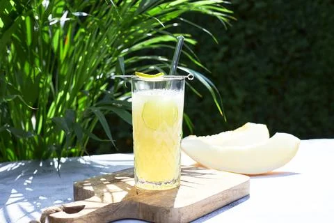 Refreshing summer cocktail, melon smoothie with ice and lime. The concept of Stock Photos