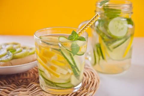 Refreshing summer drink with lemon, ginger, fresh cucumber and mint. Stock Photos
