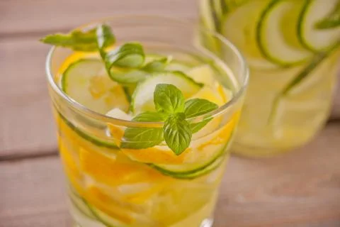 Refreshing summer drink with lemon, ginger, fresh cucumber and mint. Stock Photos