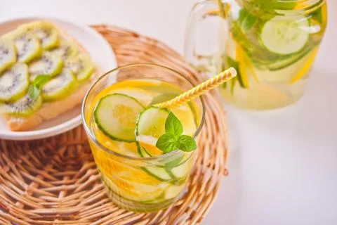 Refreshing summer drink with lemon, ginger, fresh cucumber and mint. Stock Photos