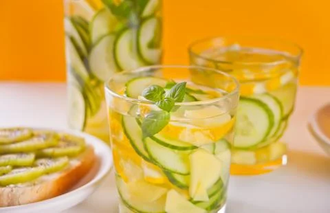 Refreshing summer drink with lemon, ginger, fresh cucumber and mint. Stock Photos