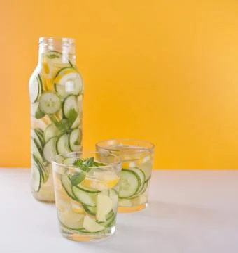 Refreshing summer drink with lemon, ginger, fresh cucumber and mint. Stock Photos