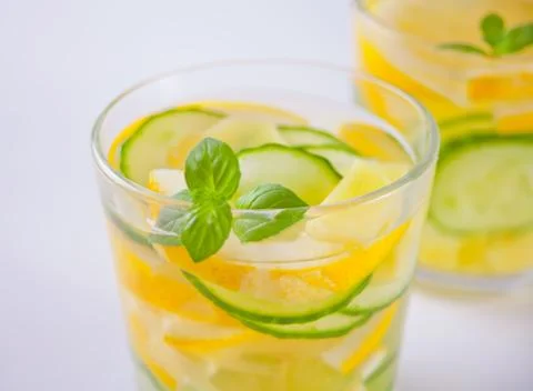Refreshing summer drink with lemon, ginger, fresh cucumber and mint. Stock Photos