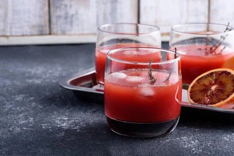 Refreshing summer drink of red oranges in glasses on gray background, lemonad Stock Photos