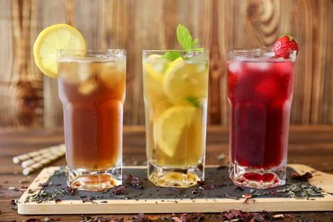 Refreshing summer drinks featuring iced tea, lemonade, and berry beverage served Stock Photos