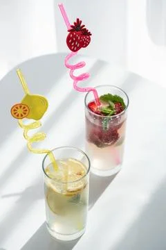 Refreshing summer drinks with fruit and whimsical straws Stock Photos