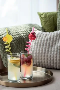 Refreshing summer drinks with fruity straws on a tray Stock Photos