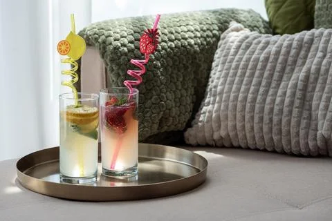 Refreshing summer drinks with lemon and strawberry on a couch Stock Photos