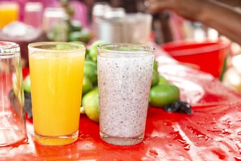 Refreshing Summer Drinks: Lemon, Mango Juice and Basil Seed Sherbet. 스톡 사진