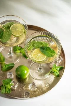 Refreshing summer drinks with lime and mint on a tray Stock Photos