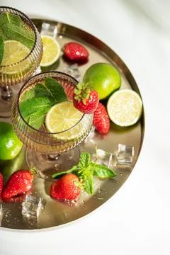 Refreshing summer drinks with lime, mint, and strawberry Stock Photos