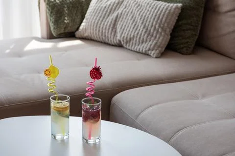 Refreshing summer drinks on a sofa table relaxing at home Stock Photos