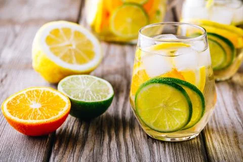 A refreshing summer ice-cold drink. White wine sangria in glass with lime, le Stock Photos